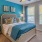 Dog-Friendly townhomes in Asheville, NC - Reserve at Biltmore Park - a carpeted bedroom with a bed, a nightstand, lamp, overhead lighting, and a window peering into the outside