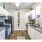Townhomes in Asheville, NC - Reserve at Biltmore Park - a kitchen with gray countertops, cool lighting,  marbled countertops, and wood-style flooring